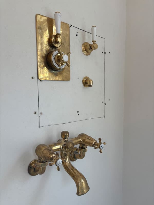 Plaster around shower controls before repair